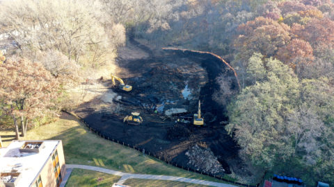 Aerial view of excavators and a bulldozer working at Seminary Pond. 